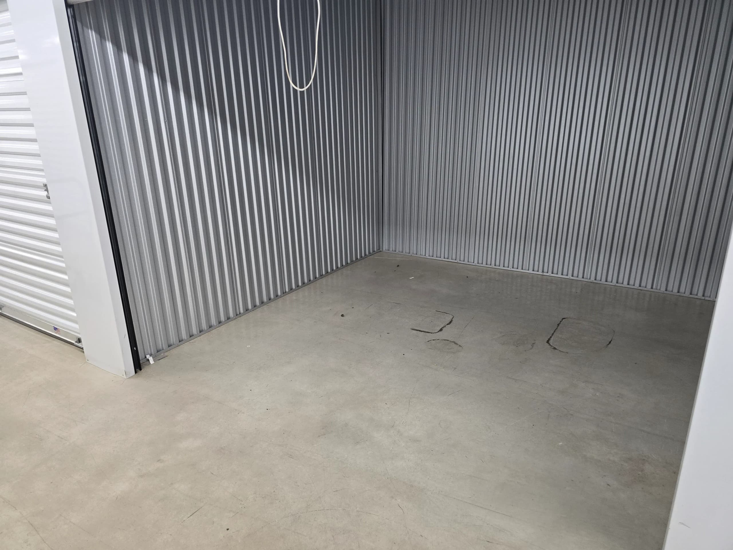Empty metal storage unit with a concrete floor after cleanout in Kingsport, TN