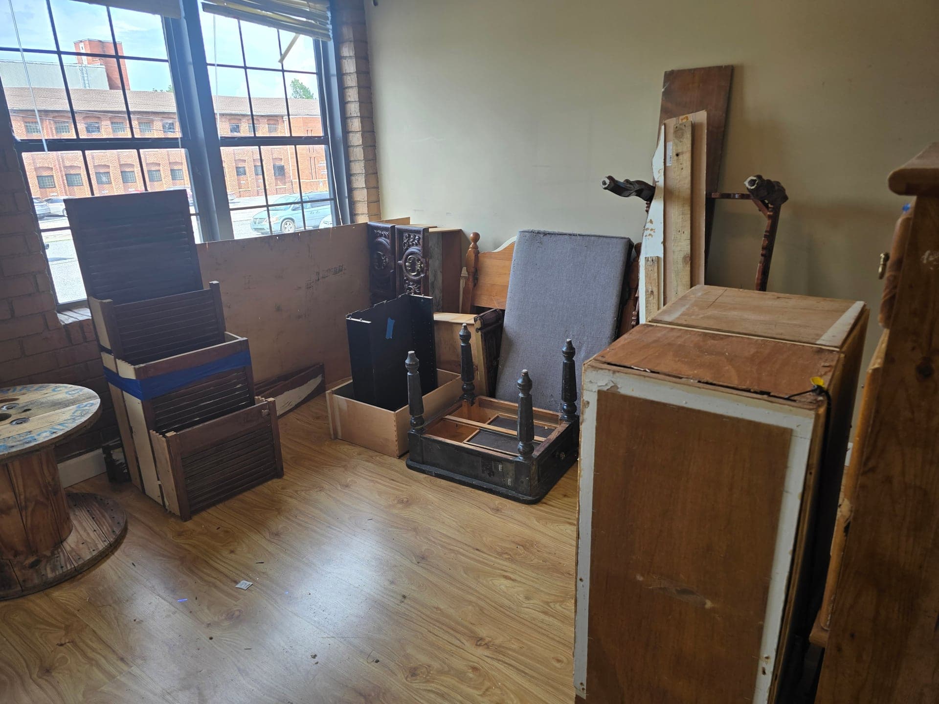 Cluttered room with dressers, tables, and other furniture before removal in Johnson City, TN