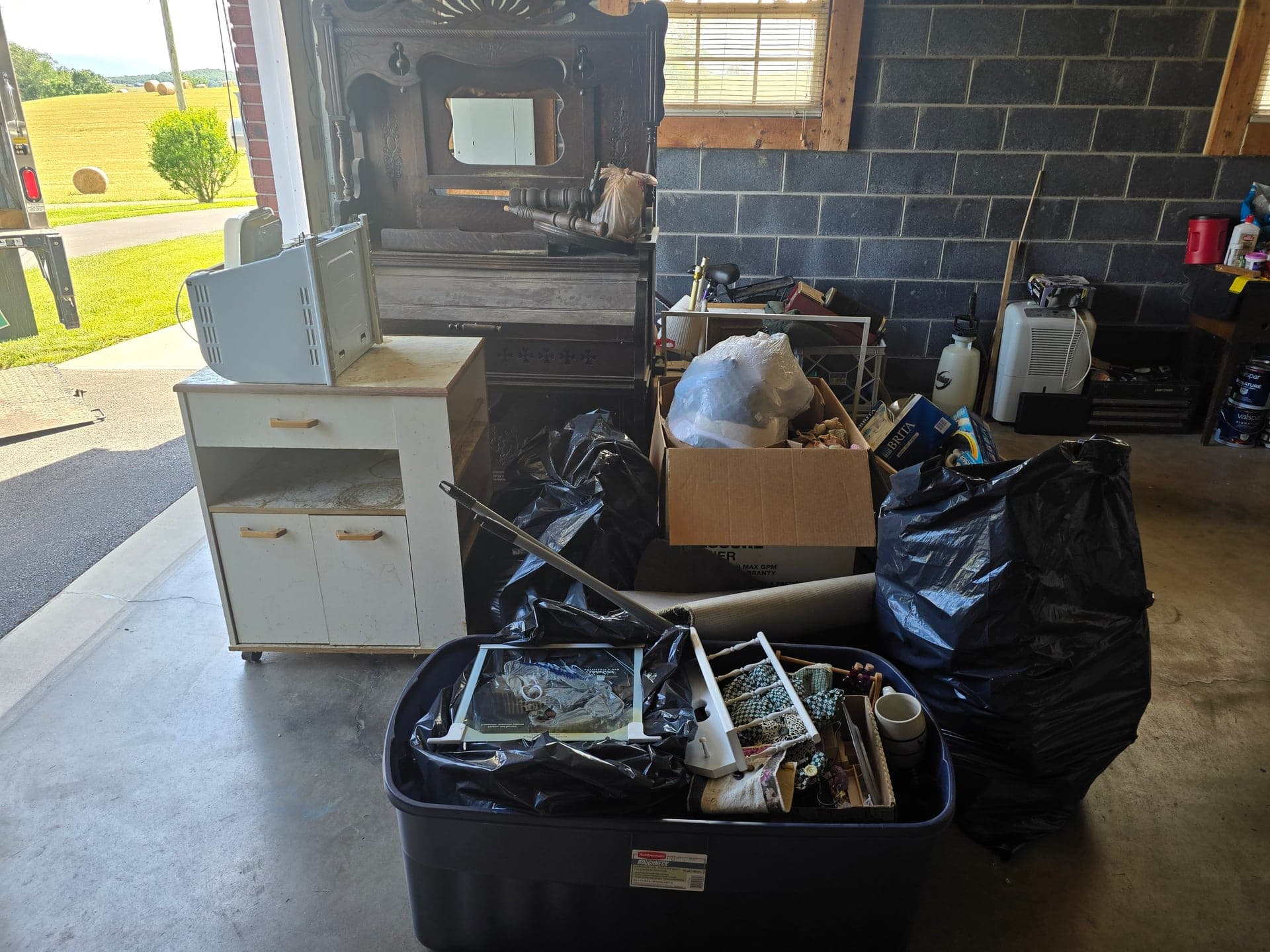 Garage and outdoor storage clutter before a cleanout in Bristol, TN