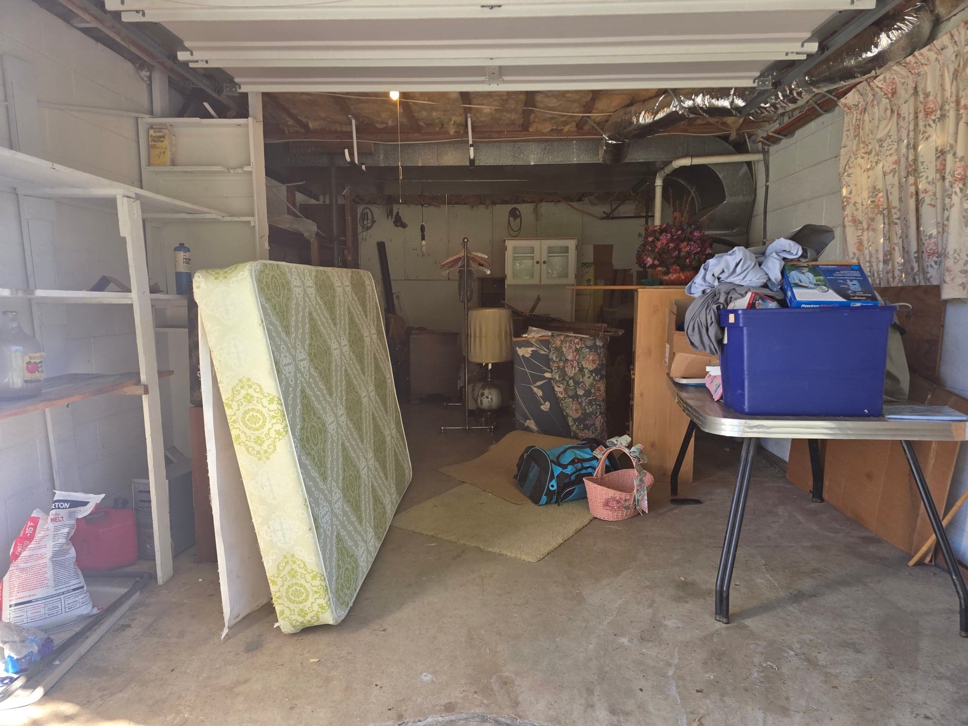 Cluttered garage before a cleanout in Johnson City, TN