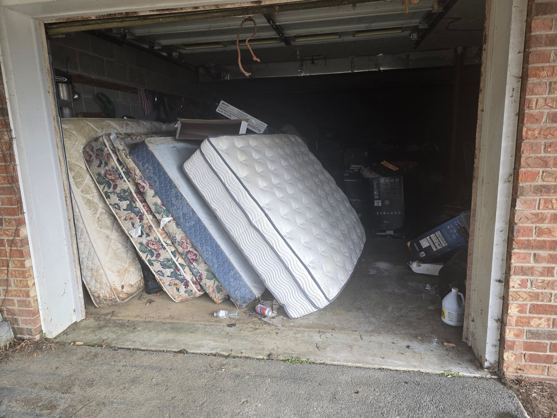 Cluttered garage before a cleanout in Kingsport, TN