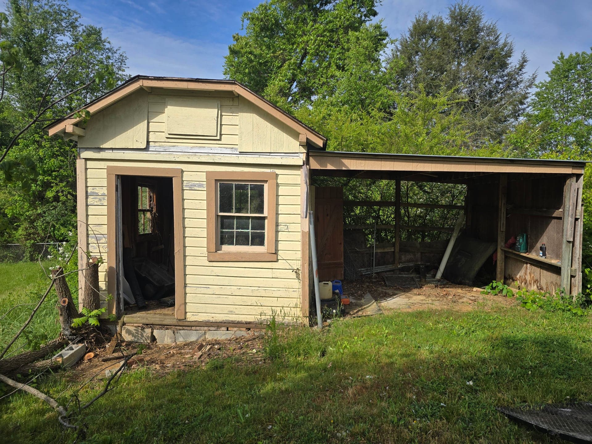 Weathered wooden shed with an attached lean-to in a Kingsport, TN backyard