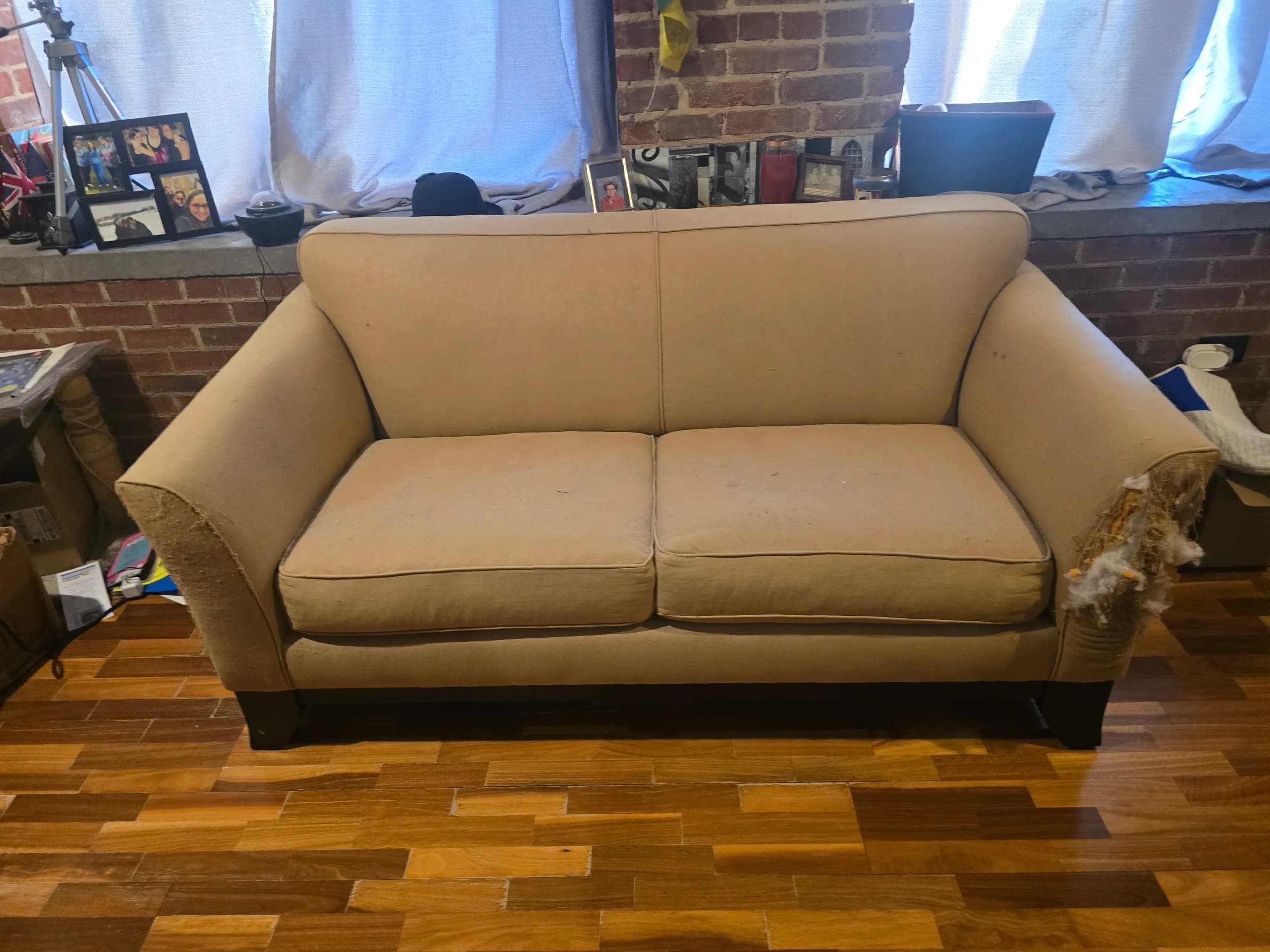 Sofa staged for furniture removal by Kraken Junk Removal