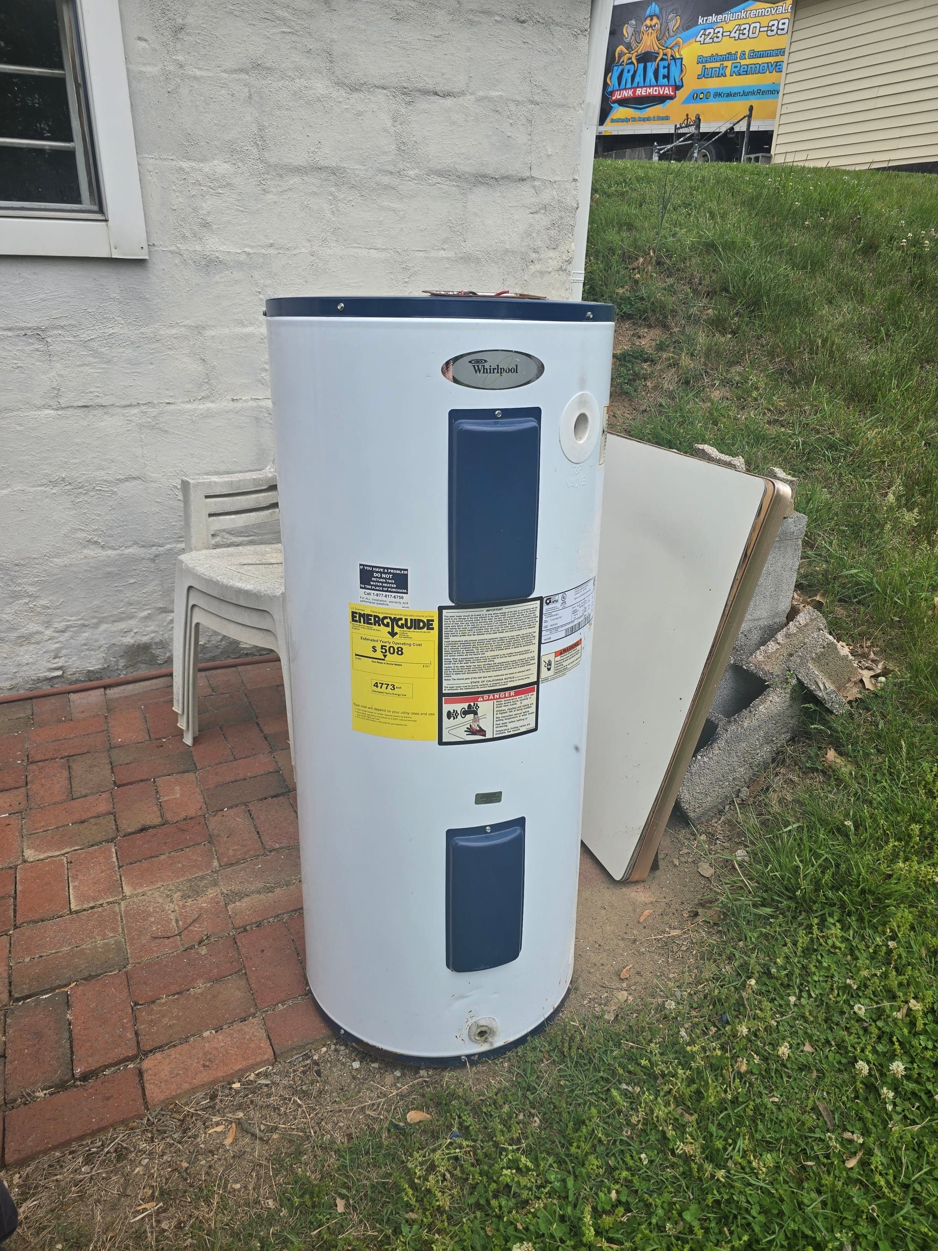 Disconnected white water heater staged outdoors for Kraken Junk Removal haul-away