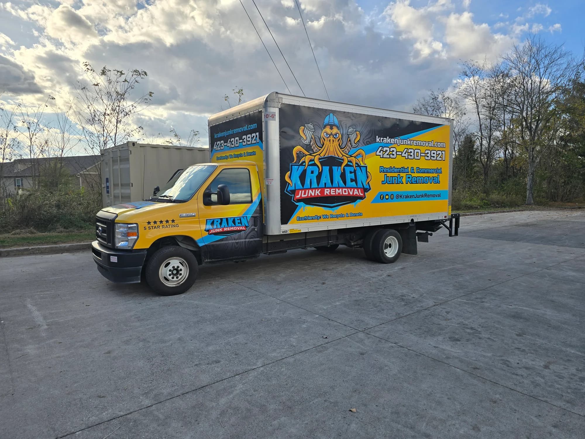 Kraken Junk Removal branded truck showing the company Kraken logo wrap, phone number, and website