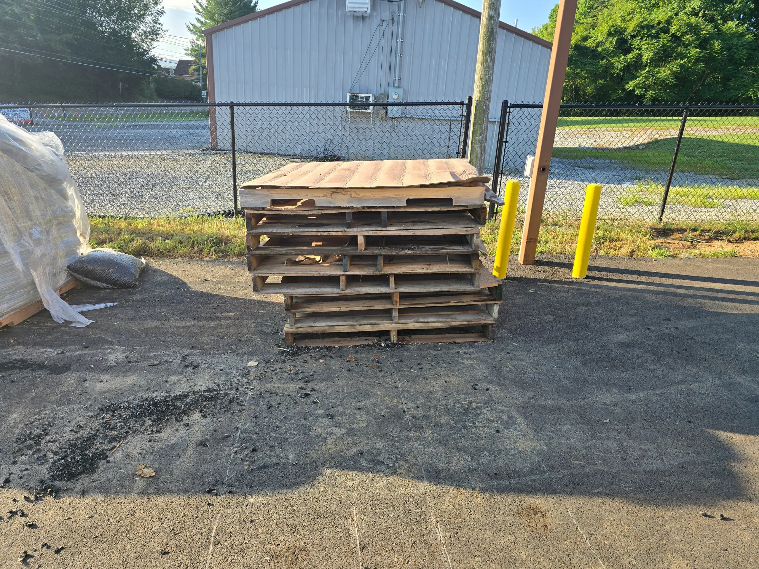 Stacked wooden pallets before construction debris removal by Kraken Junk Removal