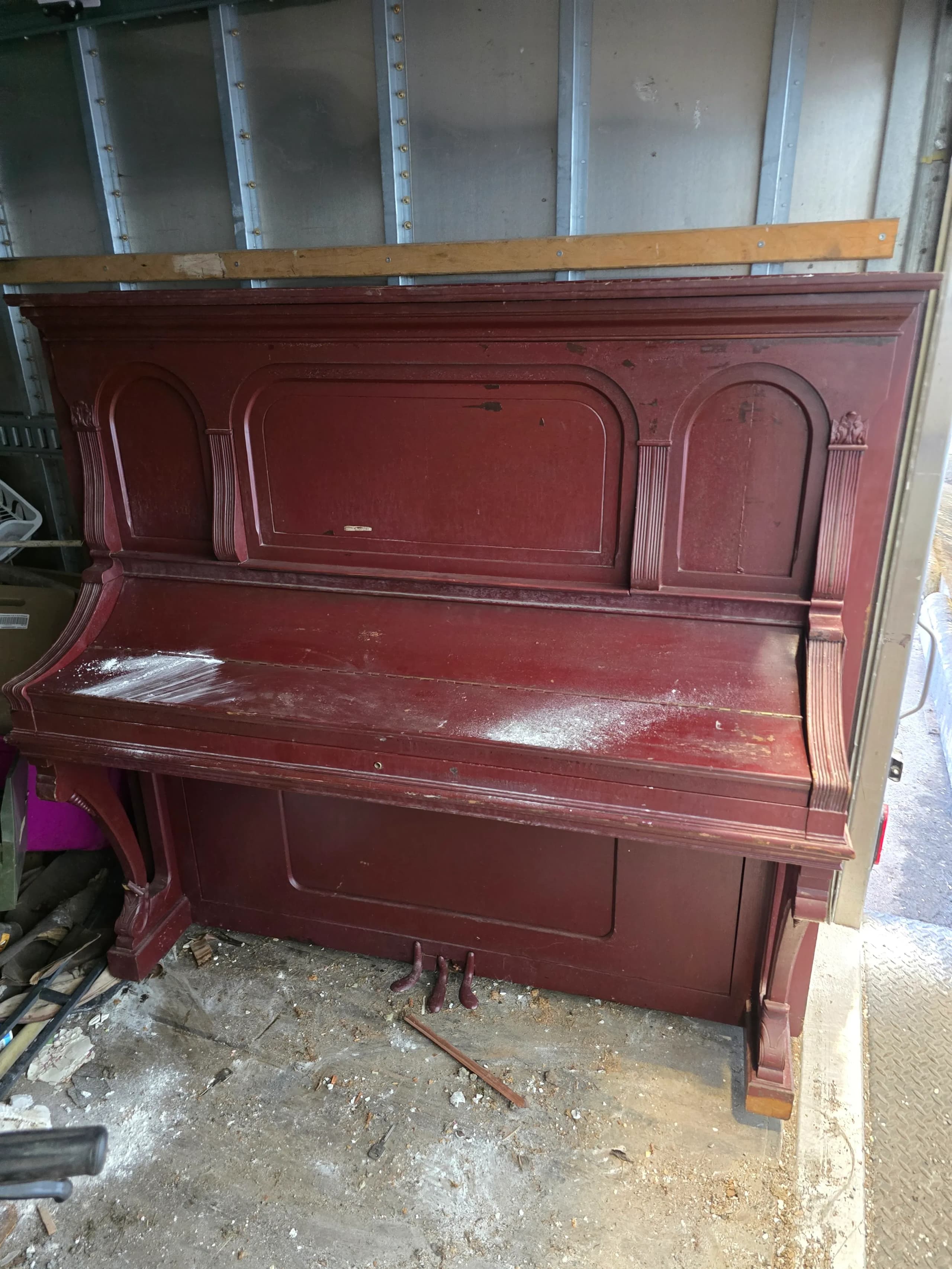 Full-size antique upright piano removal by Kraken Junk Removal