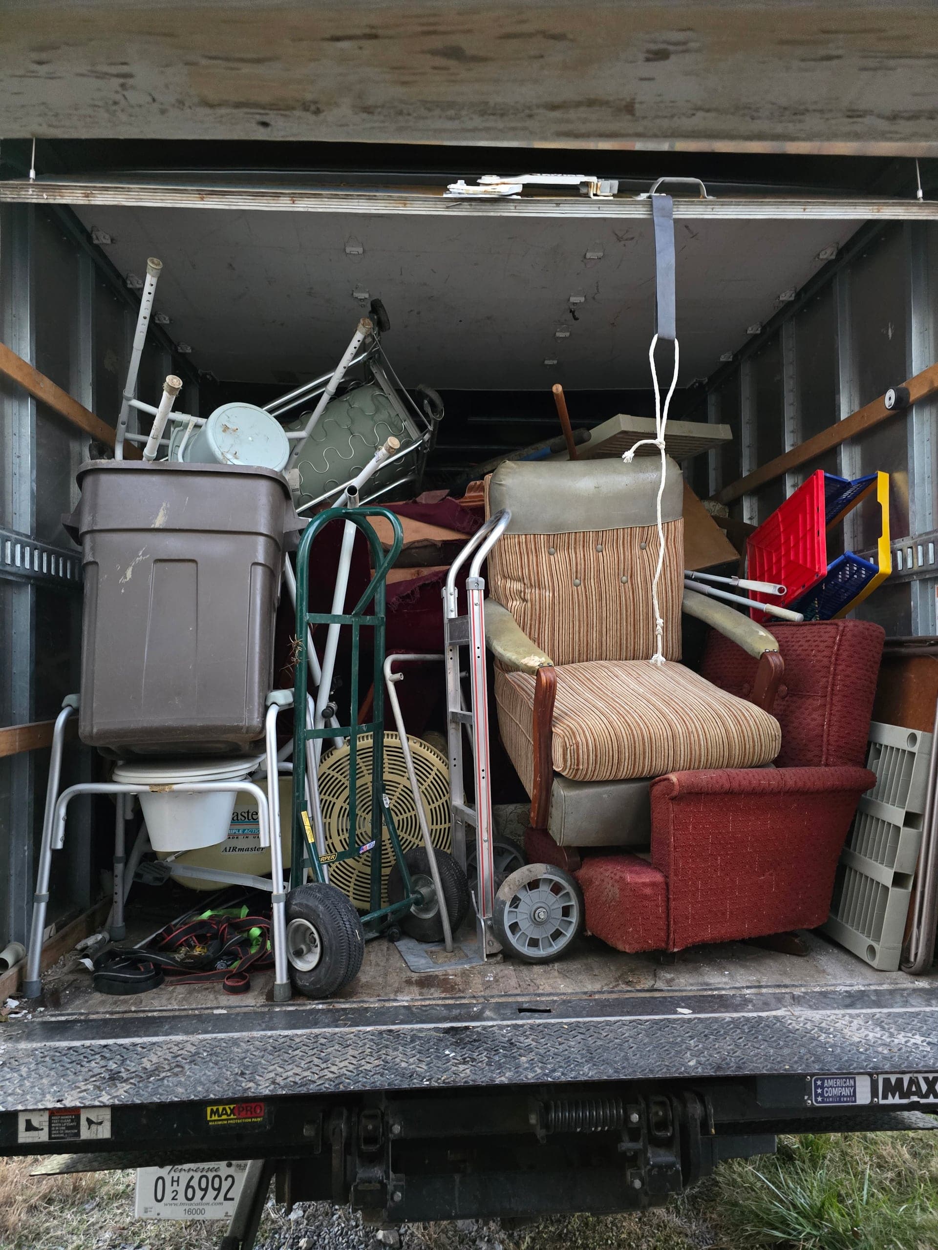 Recliners and other furniture loaded in a Kraken Junk Removal truck after a Johnson City job