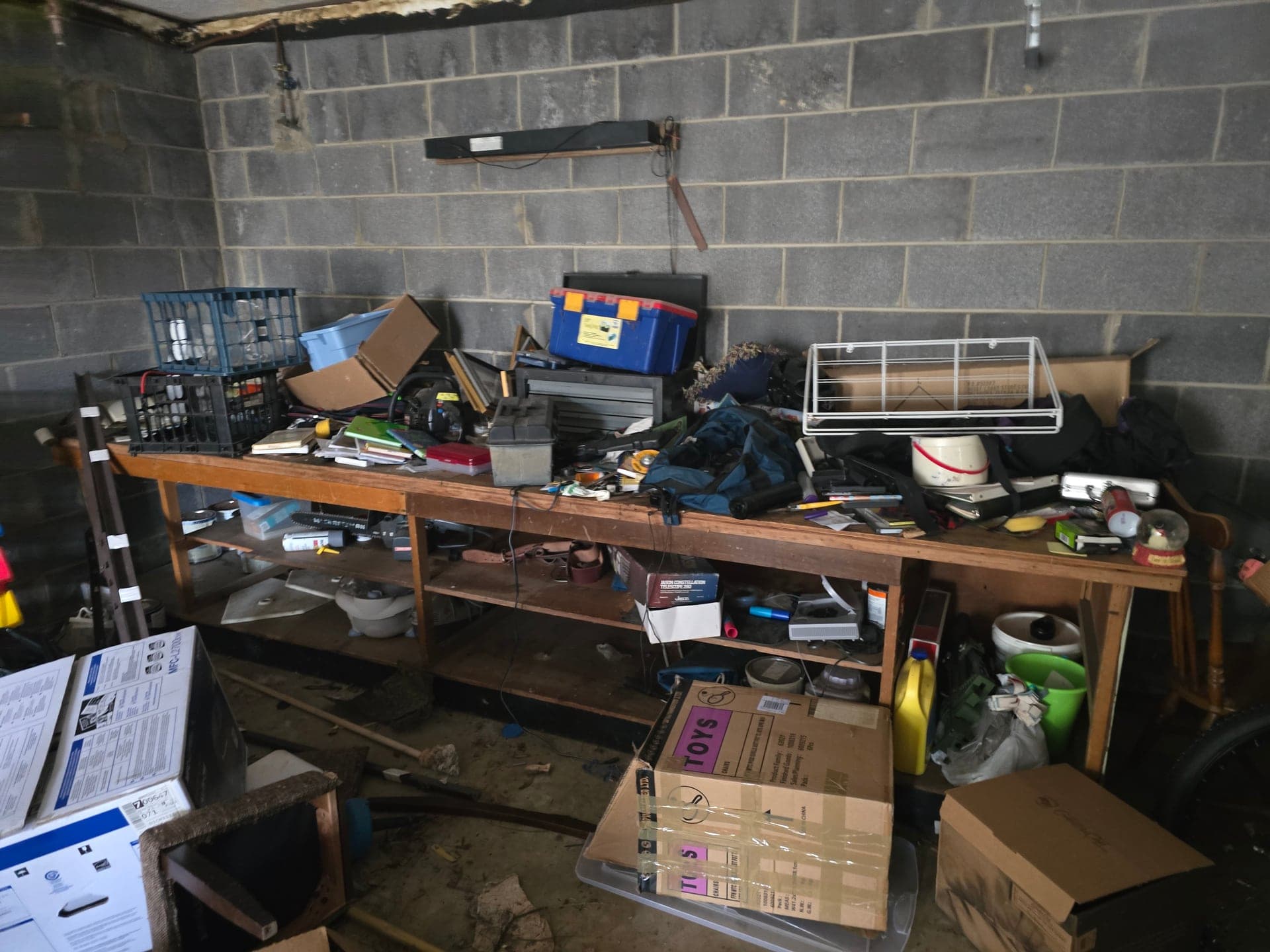 Workbench and shelving packed with tools and storage items in a garage
