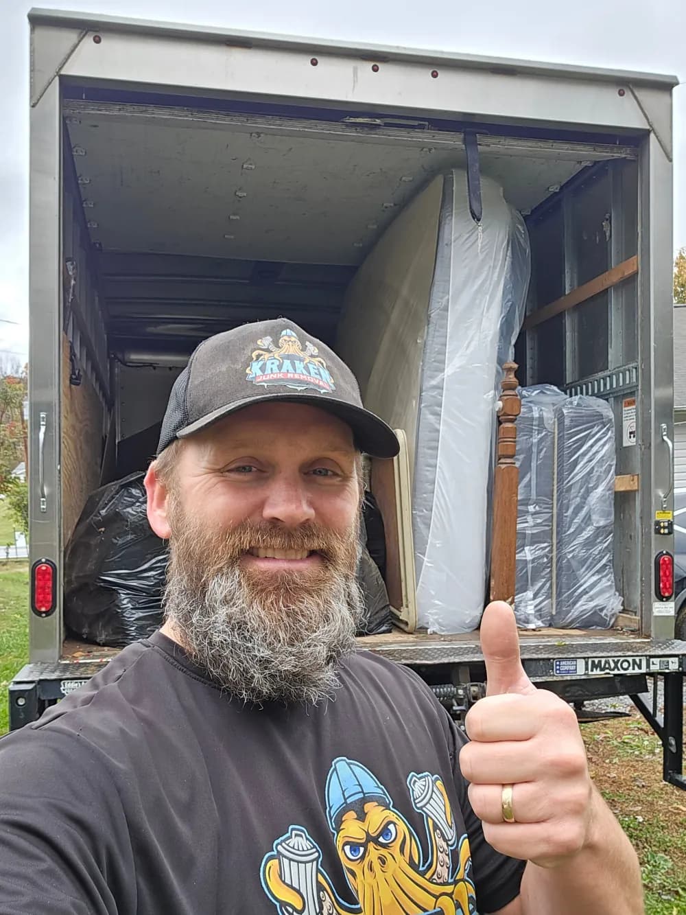 Austin, owner of Kraken Junk Removal, standing in front of a completed junk removal load in Johnson City, TN.