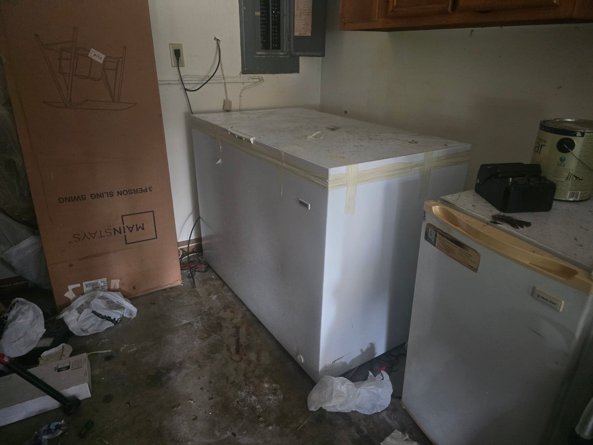 Chest freezer and mini-fridge staged indoors for refrigerator and freezer removal