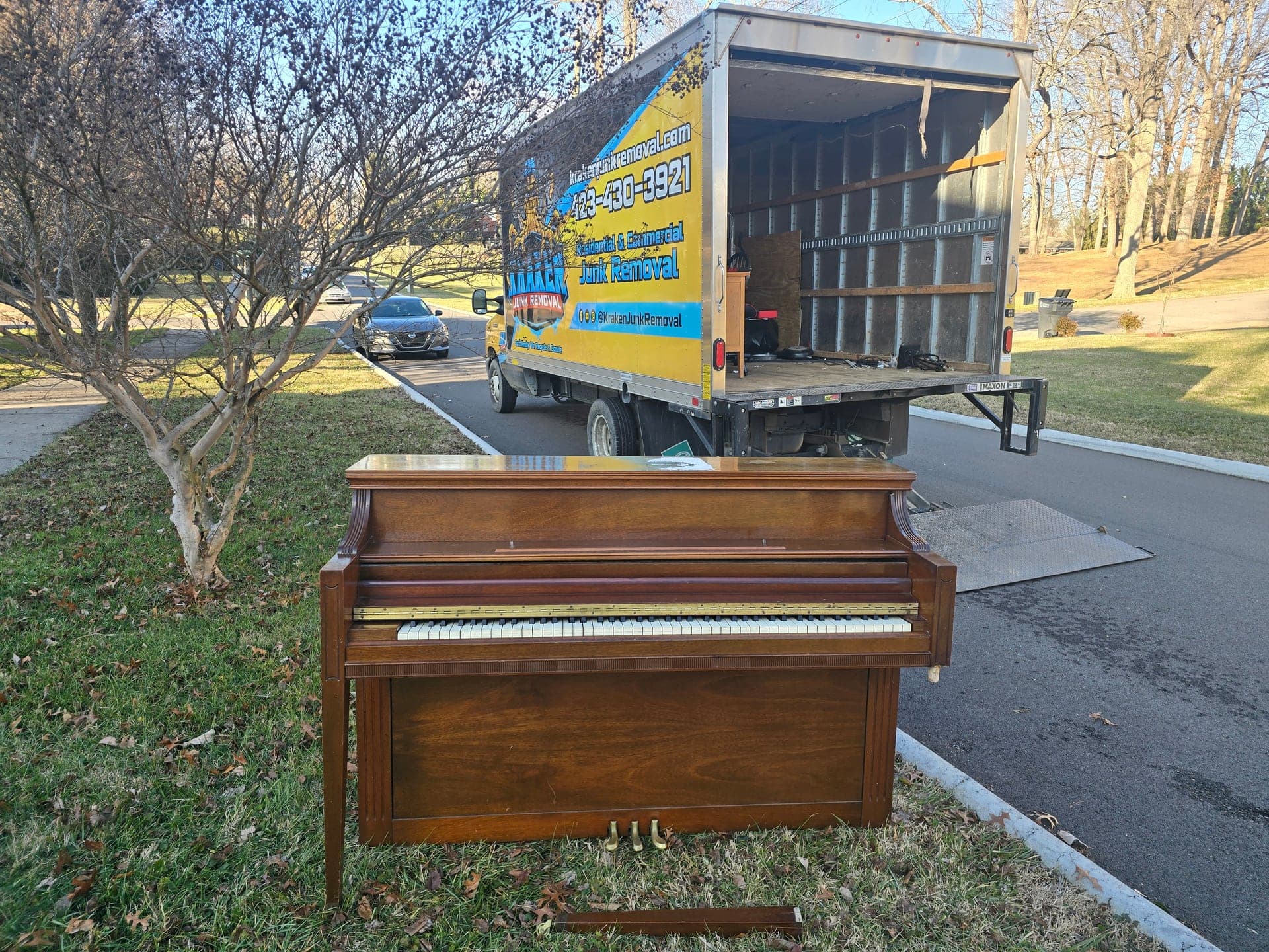 Upright piano staged for specialty item removal in Johnson City, TN