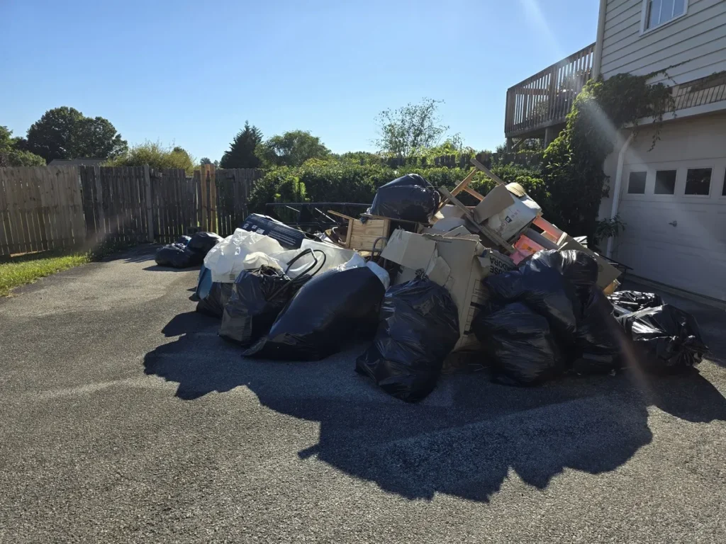 Kraken Junk Removal efficiently handling bulk waste removal in Tri-Cities, TN, with various items including bags, boxes, and discarded furniture collected for disposal.