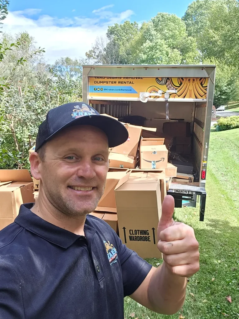 Kraken Junk Removal team member standing in front of box truck providing Cardboard Removal Service for a residential customer.