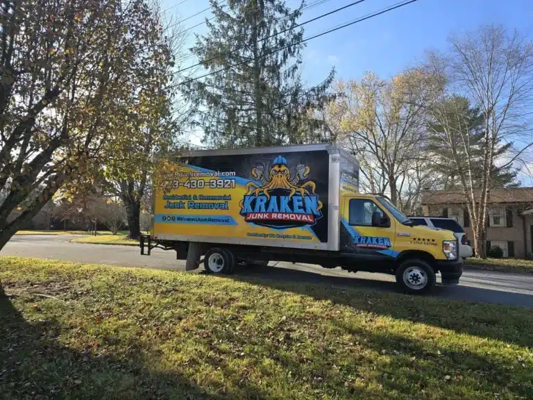 Kraken Junk Removal truck parked at an estate clean out site in Tri-Cities, TN, prominently displaying the company logo and contact information, ready for efficient service.